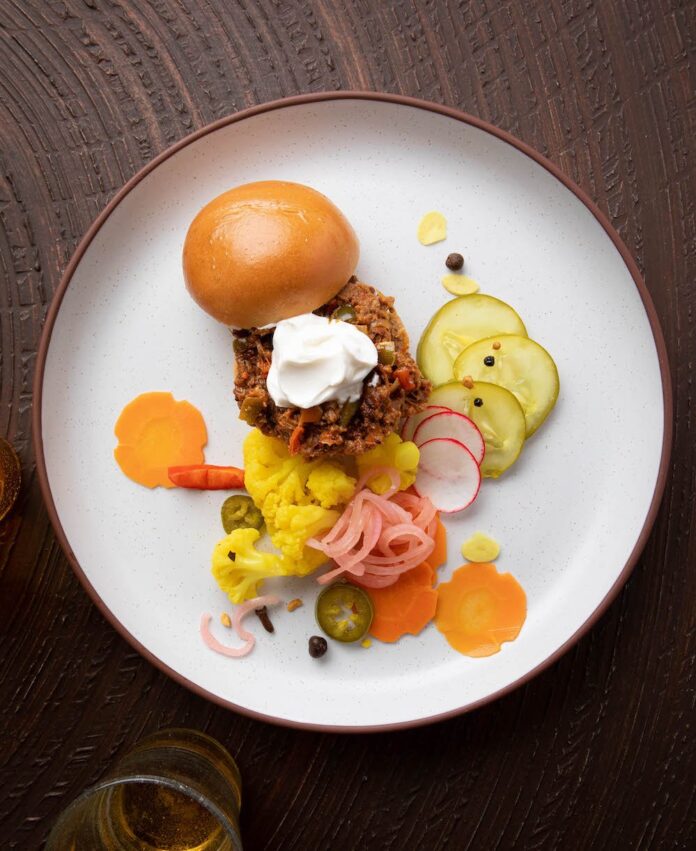 Lamb Sloppy Joes deconstructed on a white plate.