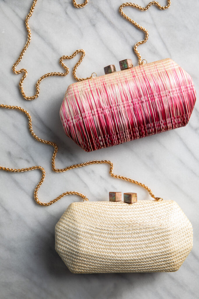 A flat-lay photo of two straw purses from Kristi Boutique.