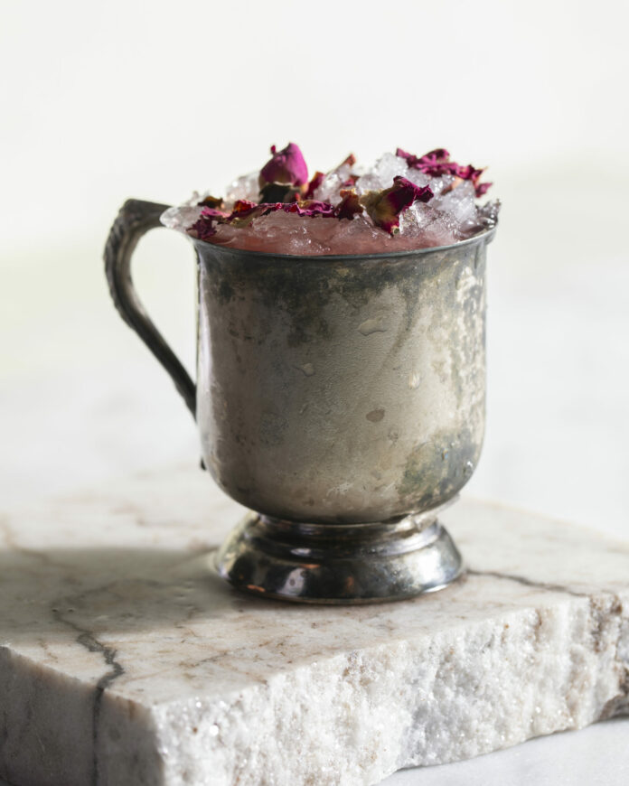 Parfait Amore Gulab - TABLE Magazine A pink Parfait Amour Gulab cocktail sits in a silver mug.