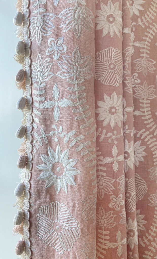 A photo detail of pink floral curtains by Suzanne Tucker Home. 