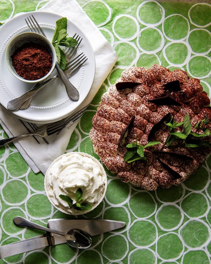 An aerial view of Chocolate Mint Pie with a side of whipped mint cream. Chocolate Mint Pie Recipe