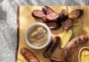 Savor the Flavors with These 6 International Pittsburgh Eateries a wooden board with a variety of sausages and mustards from a Pittsburgh eatery