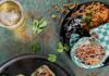 Pittsburgh’s Taco Scene Thrives Beyond Tuesday Four soft tacos on a dark tray and rice and beans with a paper wrapped burrito on a plate and a glass of beer