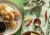 WQED’s Rick Sebak Shares Some of His Favorite Pittsburgh Restaurants a tan plate with round dumplings and a bowl of red soup with shrimp on a green table