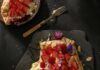 A Menu for the Zodiac Sign Gemini (May 21–June 21) Strawberry Honey Galette on a broken slab with a fork and a 1/4th of a plate on the side