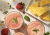 20 Recipes to Celebrate Strawberry Season Three glasses of strawberry pineapple agua fresca sit in glasses on a white picnic table surrounded by strawberries and slices of pineapple.