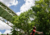 Pittsburgh’s Best Bike Trails Two bikers bike under a bridge and blue skies in Pittsburgh, Pittsburgh bike trails