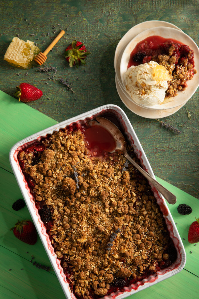 A flat-lay view of a Berry Tahini Crumble with Leona's Honey Lavender ice cream. A yummy berry dessert.