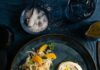 7 Fall Salad Recipes for Staying Healthy All Year Long Fennel Orange Salad served on a plate, which is placed on a blue surface