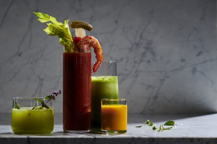 4 glasses of different sizes almost filled with green, red, and orange-colored healthy shots. Best Mocktail Recipes