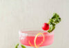 Pickled Radish Martini Pickled Radish Martini sits in a martini glass, light pink in color, with a lemon peel and radish acting as a garnish.