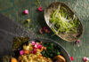Vegetarian Ramen Bowl Recipe A flay-lay image of vegetarian ramen bowls with various vegetables and garnishes. Vegetarian meal.