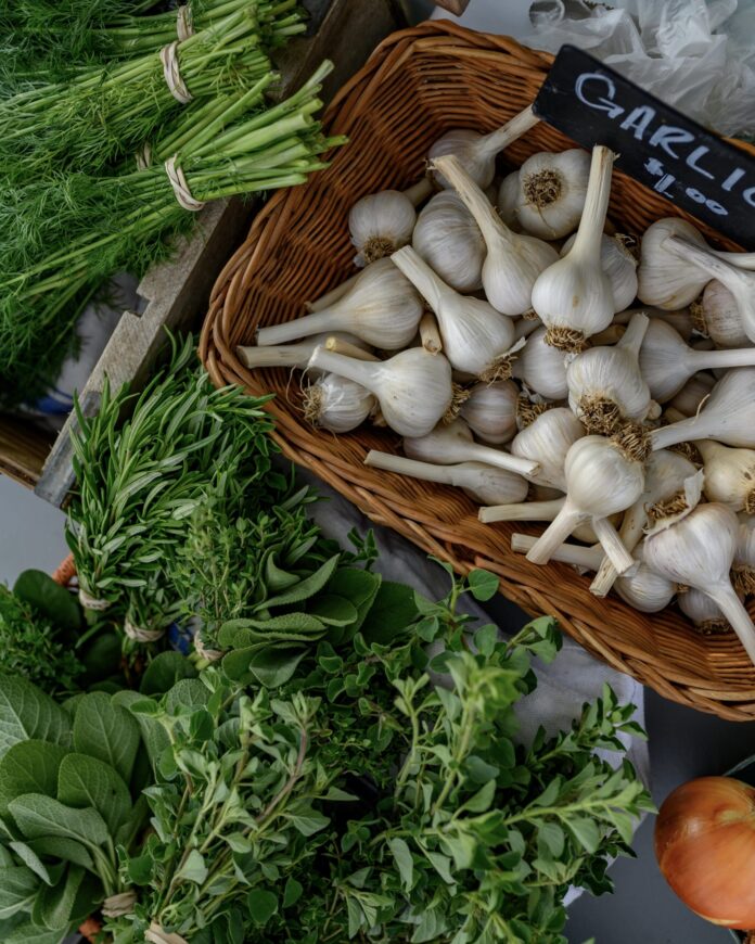 Farmers Markets 2023 fresh green herbs and a basket filled with fresh garlic