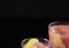 Frozen Cosmo Two Frozen Cosmos, light pink in color, sit in glasses garnished by limes.