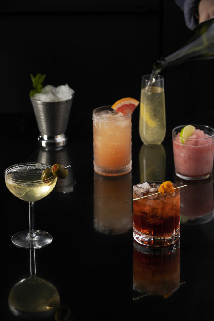 six classic cocktails of various colors sit in glasses of different shapes and sizes. classic cocktail recipes