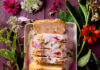 Milkweed Flower Pound Cake An aerial view of Milkweed Flower Pound Cake sitting sliced on a white serving tray, surrounded by flowers. Milkweed Flower Pound Cake Recipe