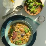 An aerial view of corn chower in a light blue-green bowl. corn chowder recipe
