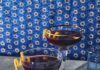 Blueberry Whiskey Sour Three dark blue-purple cocktails in rocks glasses garnished with lemon twists. Blueberry Whiskey Sour Recipe