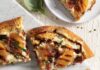 Peach and Ricotta Pizza Four slices of Peach and Ricotta Pizza sit on a wooden background. They are orange and white in color and drizzled with a brown glaze.