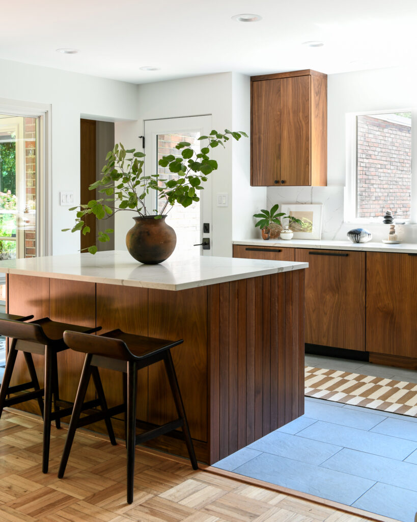 A new kitchen with dark wood cabinets and white counters.