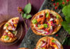 Get Peachy this Summer with these 20 Peach-Based Recipes An aerial view of three Peach Wineberry Flatbreads, with one cut into six slices. They are bright in color and sit on a black wooden slab. Peach Wineberry Flatbread Recipe