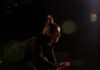 Why You Should See Quantum Theatre’s “Hamlet” The side profile of a man with a top bun against a black background. They star as Hamlet in Quantum Theater's production of the play.