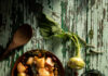 Fall Recipes to Celebrate the Autumn Equinox Flat-lay image of a pan of roasted kohlrabi resting on weathered wood table.