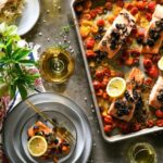 A vibrant and nutritious pan salmon and tomato meal featuring perfectly roasted salmon fillets accompanied by a colorful assortment of ripe tomatoes.