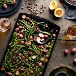 An aerial shot of a sheet pan covered in green beans and potatoes.