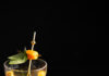 Magrouni White Negroni A pale yellow cocktail in a wine glass garnished with basil