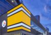 AIA Pittsburgh to Hold Second-Annual Pittsburgh Architecture Week Pittsburgh Steelers Pro Shop building lit up at night.