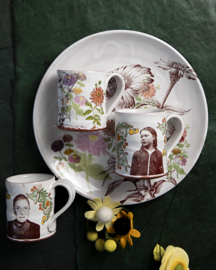 Three ceramic mugs and a ceramic plate with watercolor paintings on them.