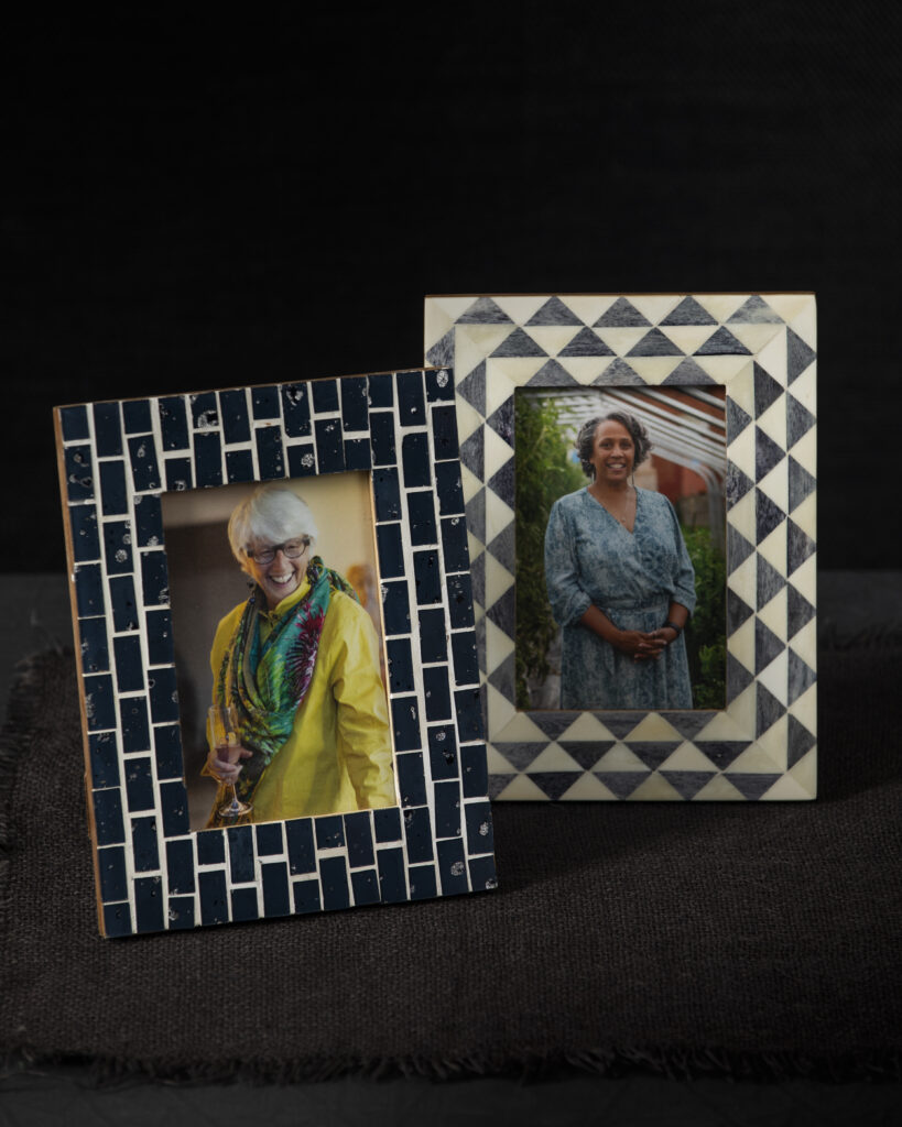 Two patterned framed with pictures of older women in them.