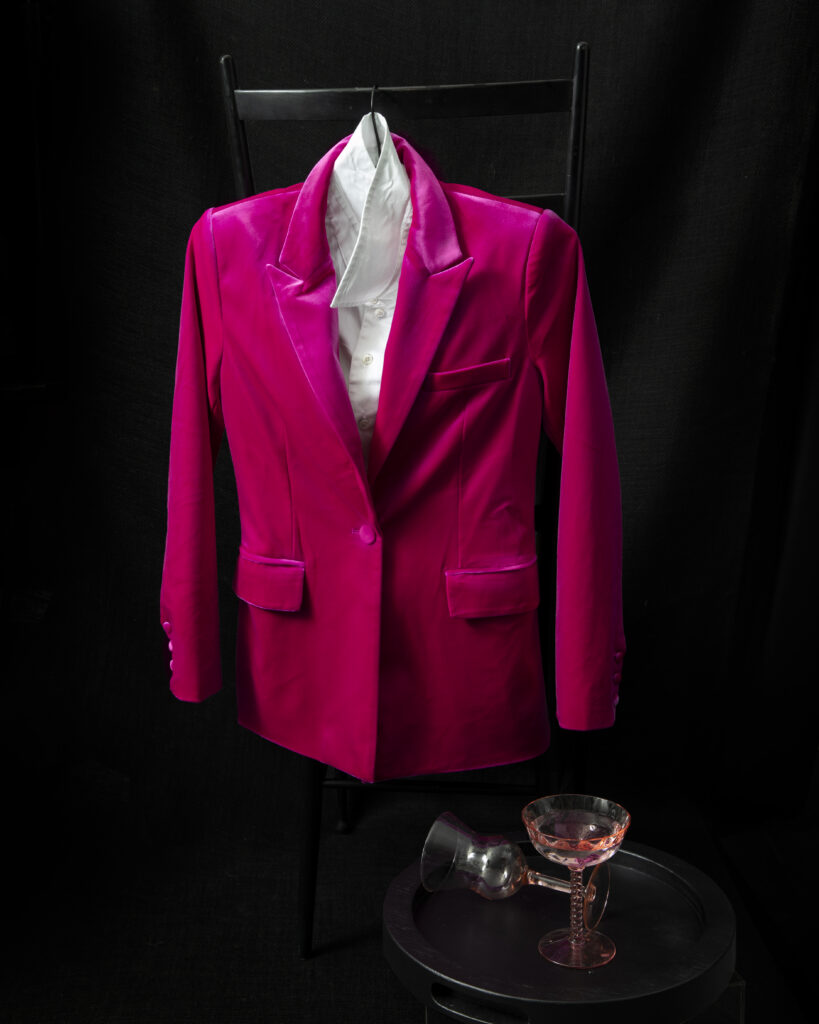 A pink velvet blazer styled with a white shirt.
