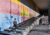 Giving Guide 2023: Carnegie Museum of Art A young man walking up the steps along a painted wall outside of the Carnegie Museum of Art