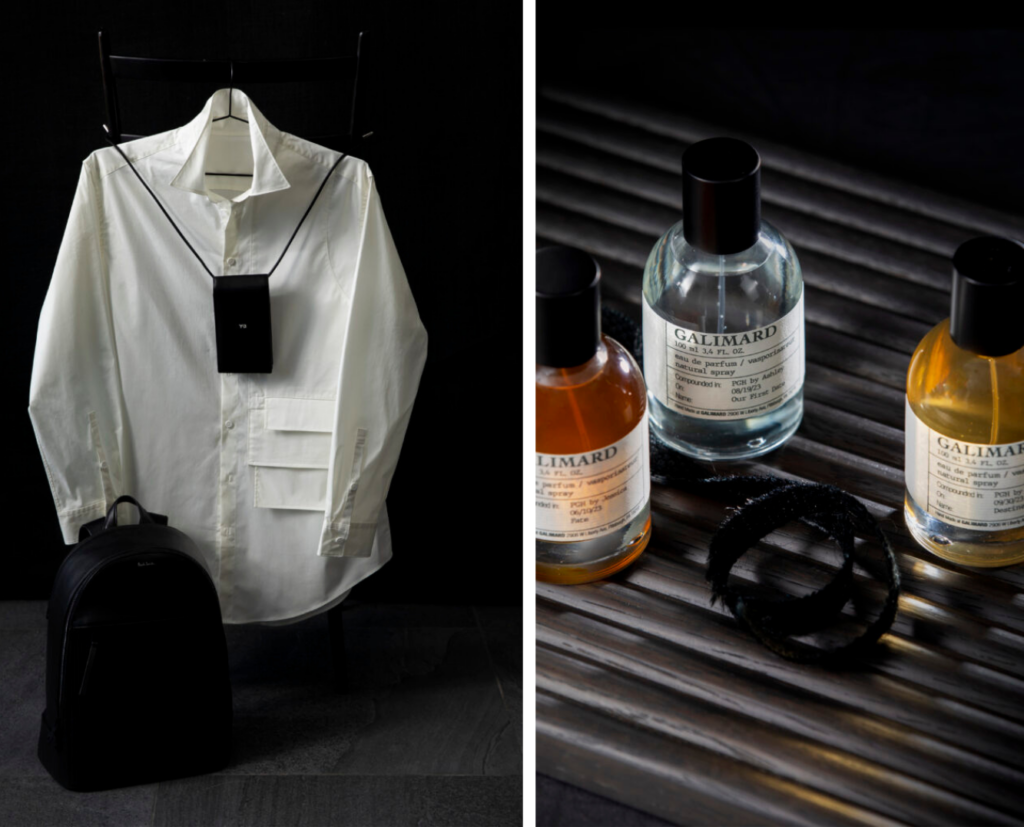 A shirt displayed with a phone holder and backpack on the left and three bottles of colored cologne on the right.