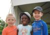 Giving Guide 2024: Traditions of Generosity Three kids stand outside at a summer camp put on by JCC of Greater Pittsburgh.