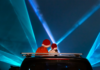 Allegheny County’s 2023 Holiday Laser Show at North Park A rear view of two people with Santa hats sitting in a convertible car watching a laser light show.