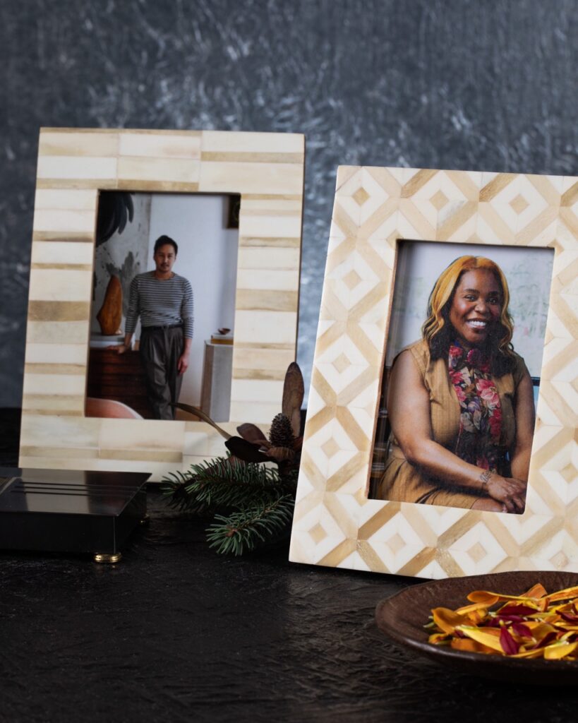 Two tan and white patterned frames sit beside each other, one with a picture of a man, and the one to the right with a photo of a woman.