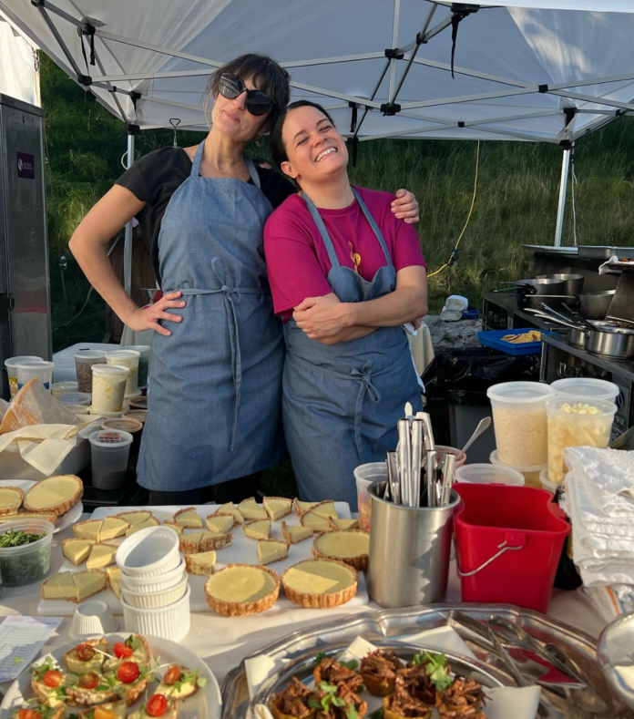 The women owners of Lilith restaurant in Shadyside Pittsburgh behind a table of their food.