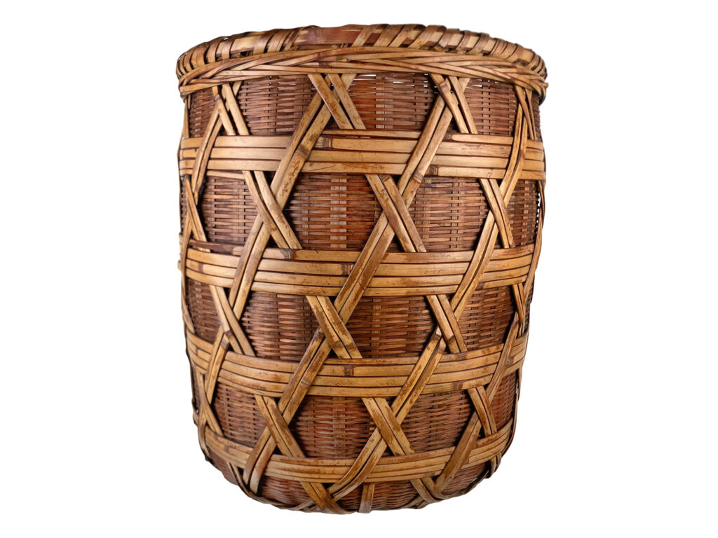 A handwoven basket on a white background.