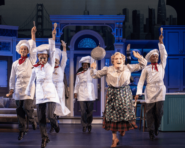 A group of actors on stage play out Mrs.Doubtfire.