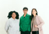 Carnegie Museum of Art Names Curators for the 59th Carnegie International Three adults standing in front of a white background, looking at the camera.