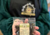 9 Places to Purchase Herbal Teas in Pittsburgh A person in a green jacket holds a clear pouch showing blueberry herbal tea inside.