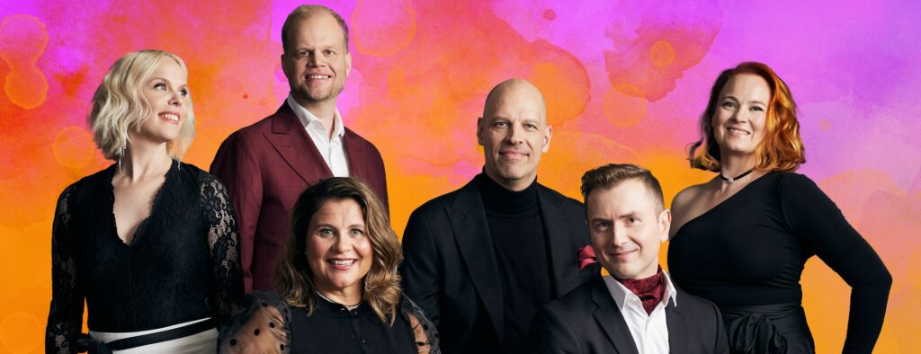 A group of singers stands against an orange and purple brightly colored background.