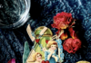 Shop Local, Pittsburgh: Valentine’s Day Gifts A vintage valentine's day card featuring two children in blue dresses sits on a dark teal background surrounded by dried roses and macarons.