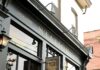 Pittsburgh Restaurant Station Announces Closing A photo of the outside of Station restaurant in Pittsburgh shows a black storefront and a sign sticking out with the shield logo.
