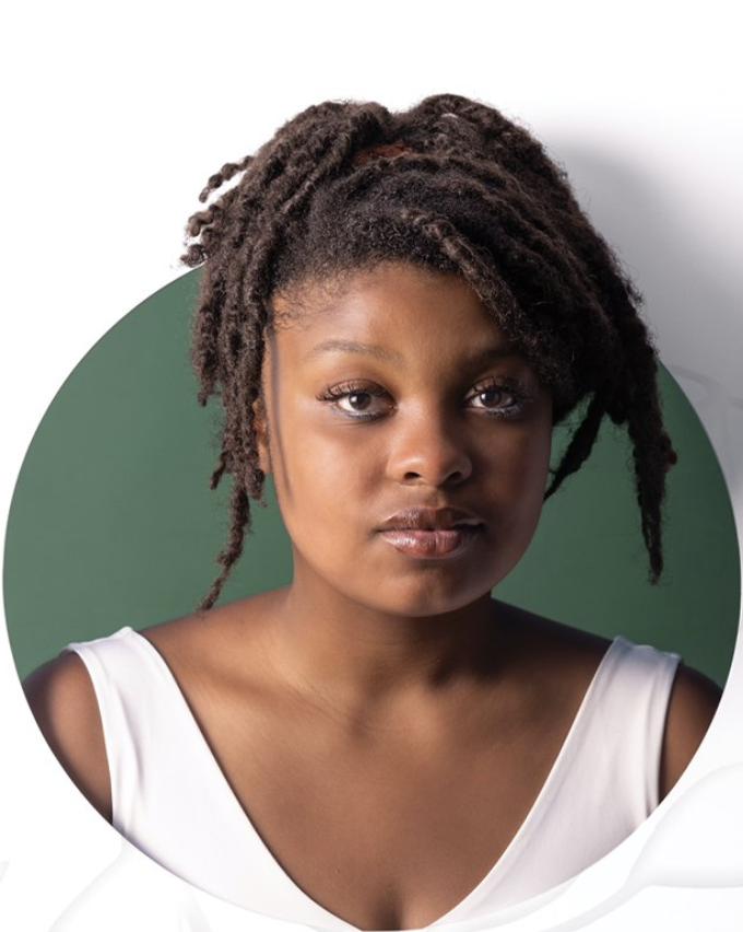 A Black woman is in a green circle wearing a white tank top with her hair up in a hair tie.