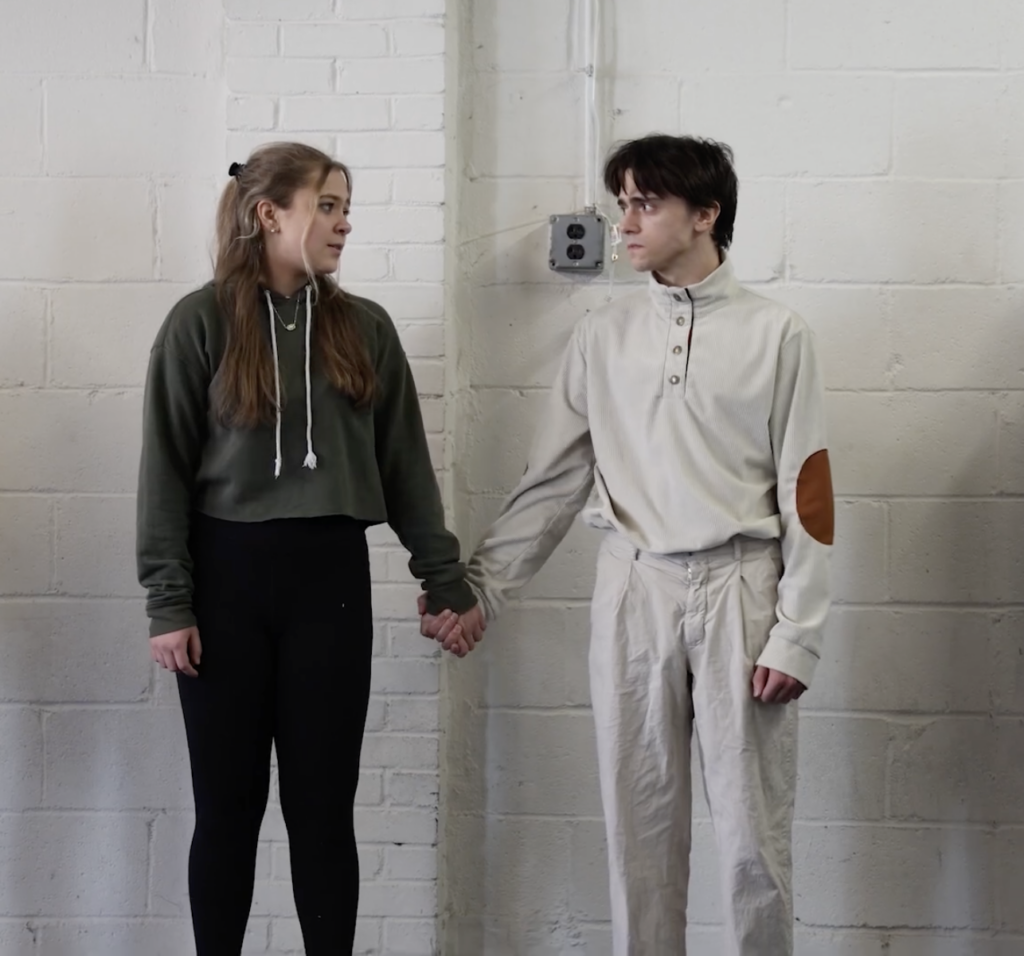 The two main actors of And Then They Came For Me hold hands in a practice for the production.