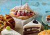 Tous les Jour French-Asian Bakery Opens in Pittsburgh A variety of cake slices in green, purple, and orange sit amongst baked breads and pastries stuffed with strawberries all from Tous les Jours.